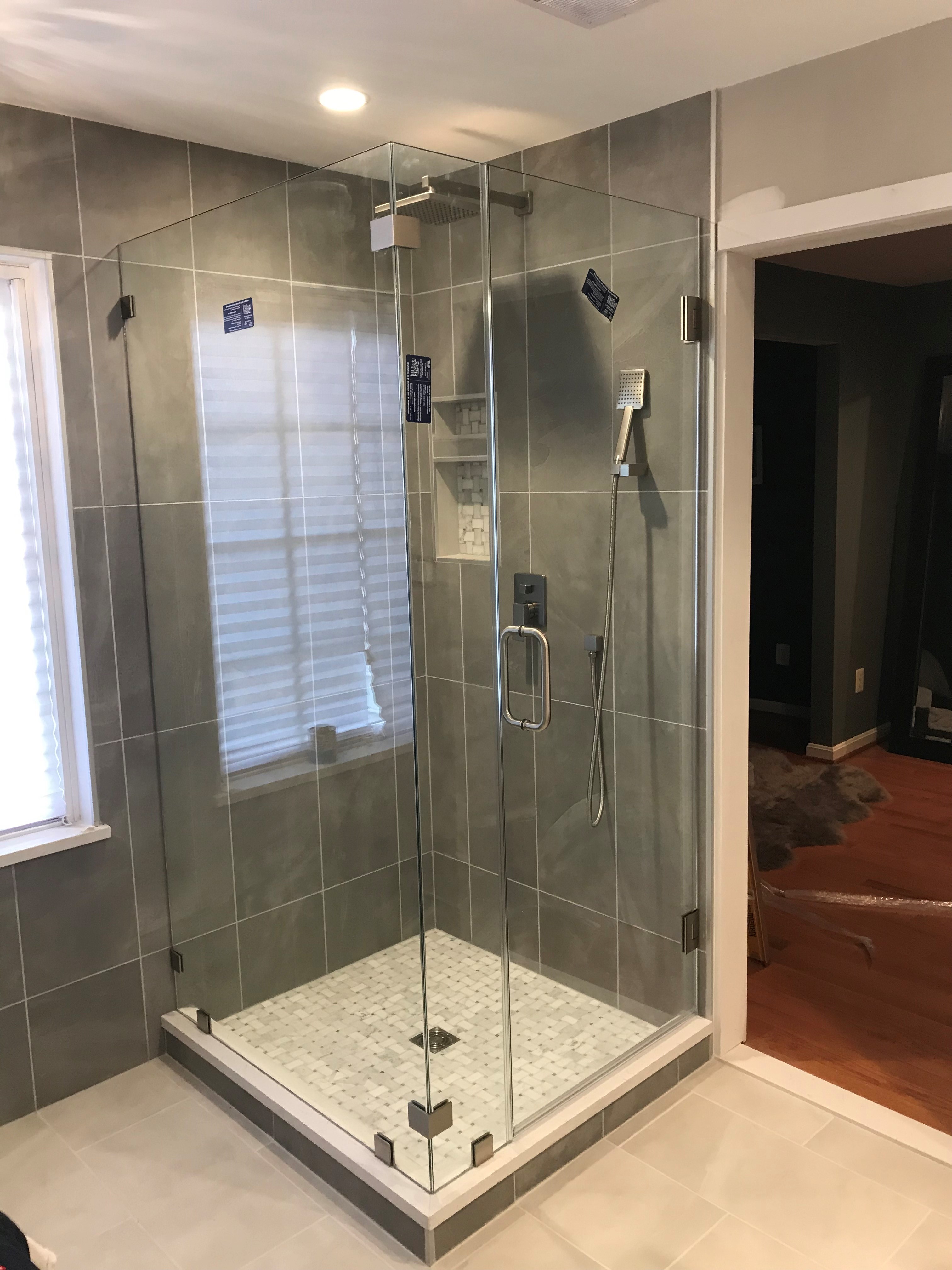 Frameless corner shower enclosure.