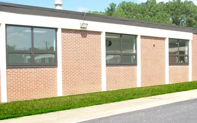 Window frontage across a low brick commercial building.