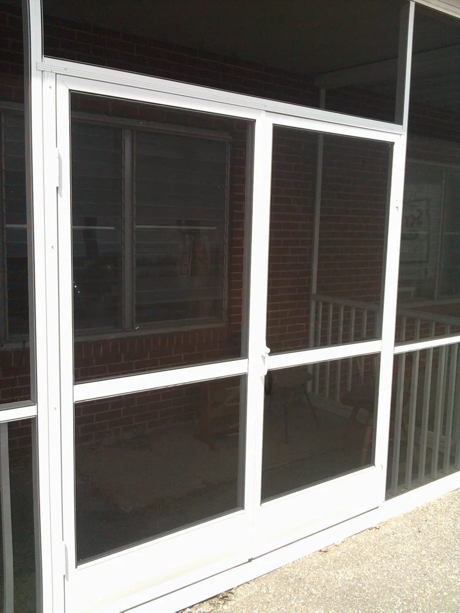 Paired white-framed screen doors with dark mesh