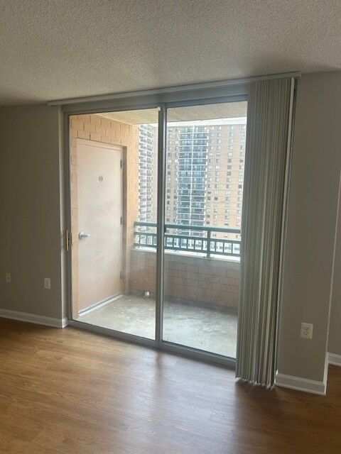 A sliding glass door opening onto an apartment balcony