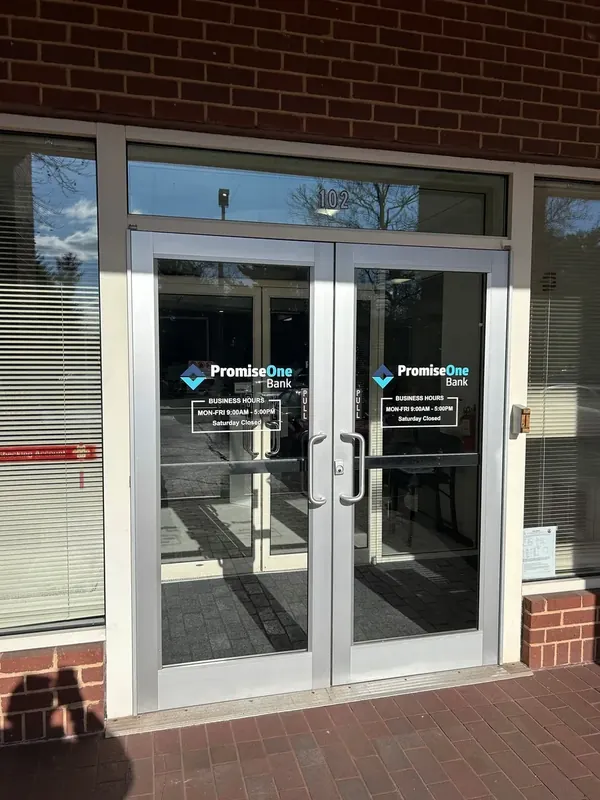 Double storefront glass doors with surrounding windows.