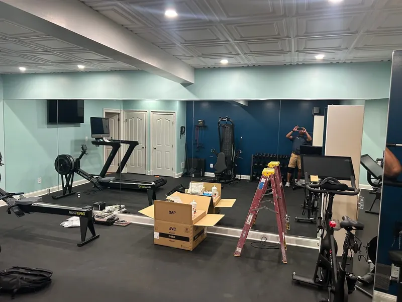 A wide view shows the home gym mirror wall.