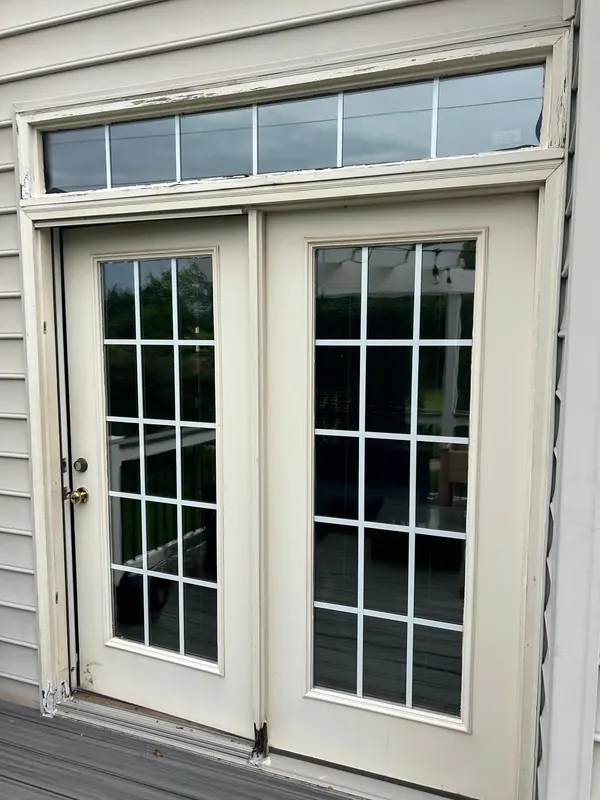 French patio doors have grid glass and a wide transom.