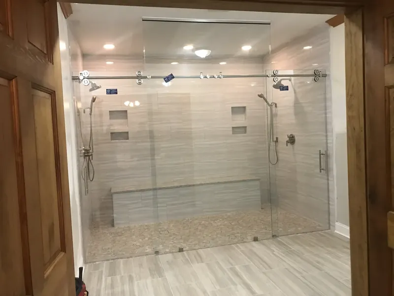 Wide sliding shower with tiled bench.