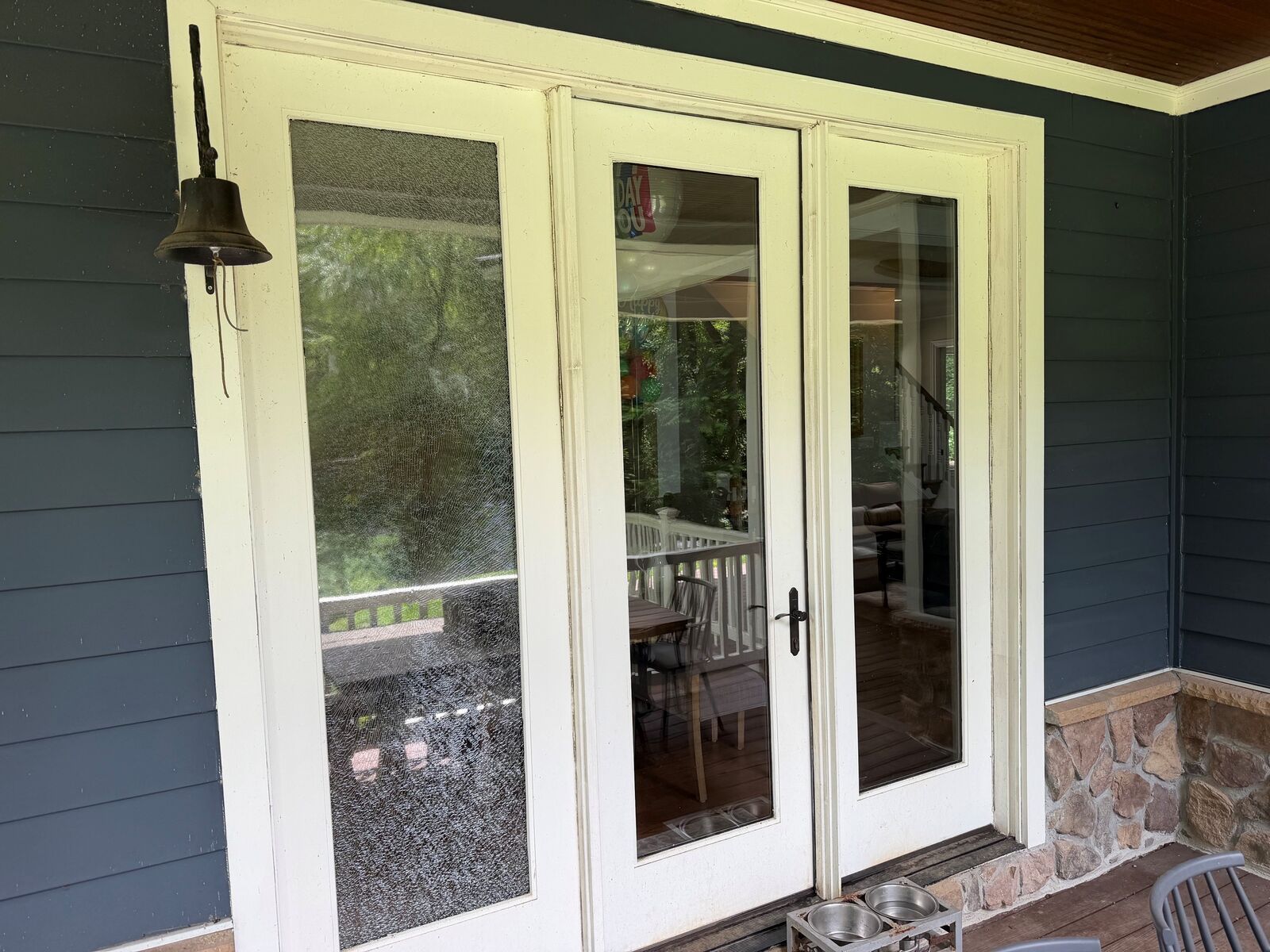 A patio door with a shattered sidelight, seen from outside