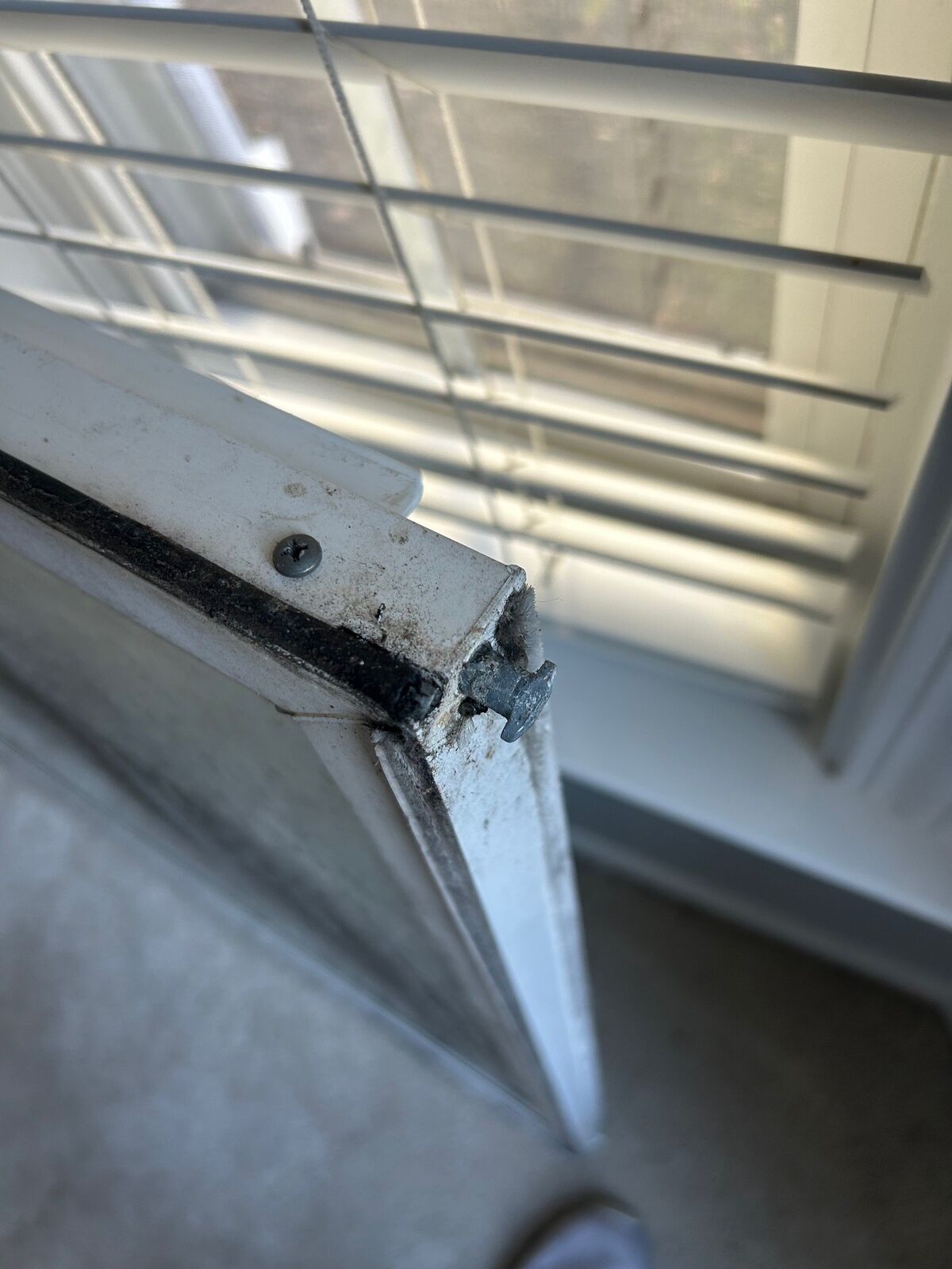 Close-up of the corner of a removed window sash showing where the glass unit sits in the frame