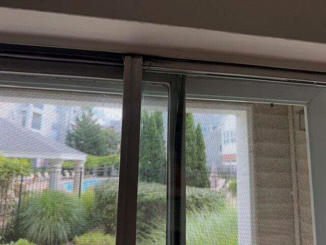 Close-up of the upper track of a patio door