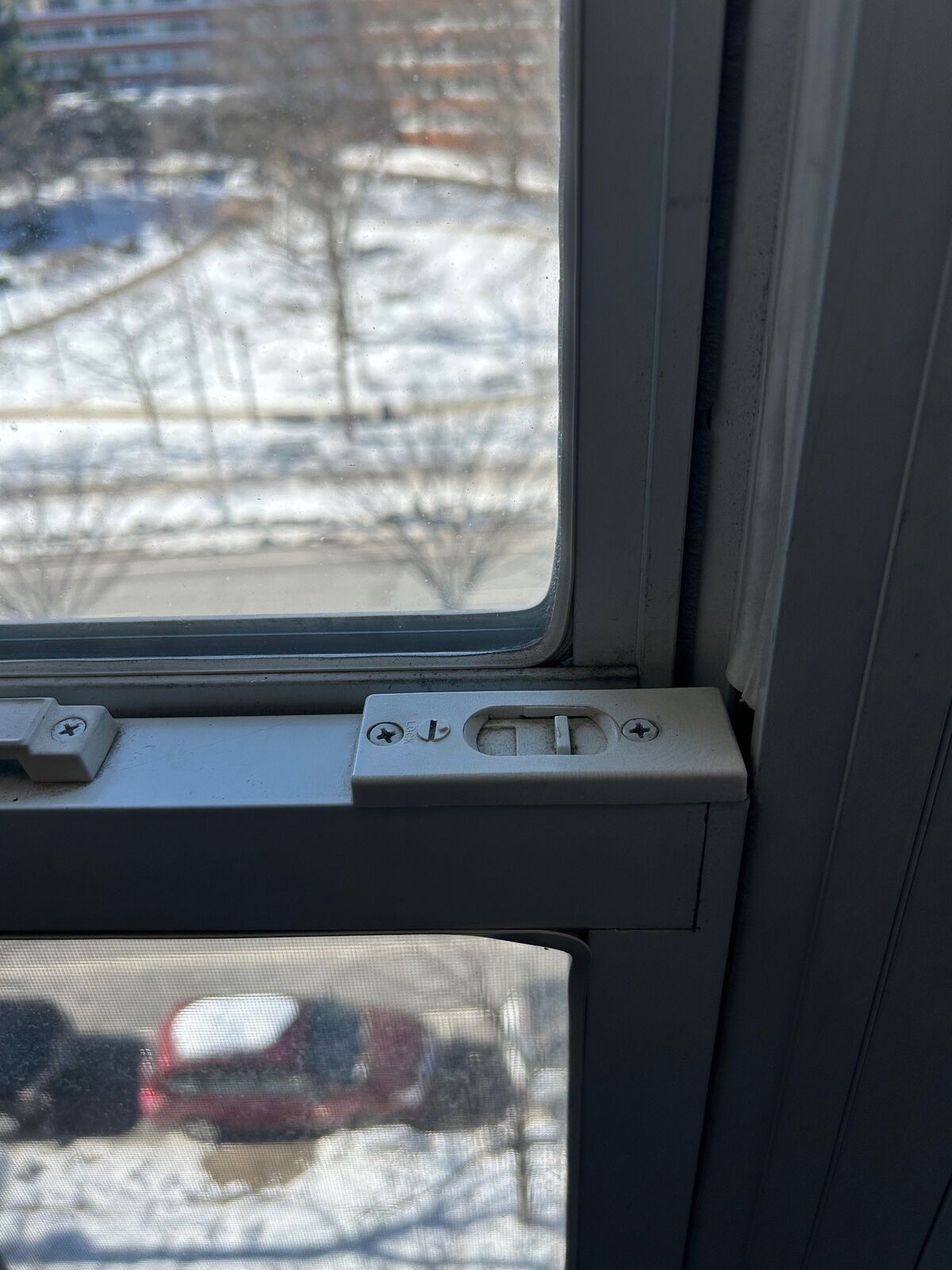 Close-up of a window sash latch where the sash meets the frame