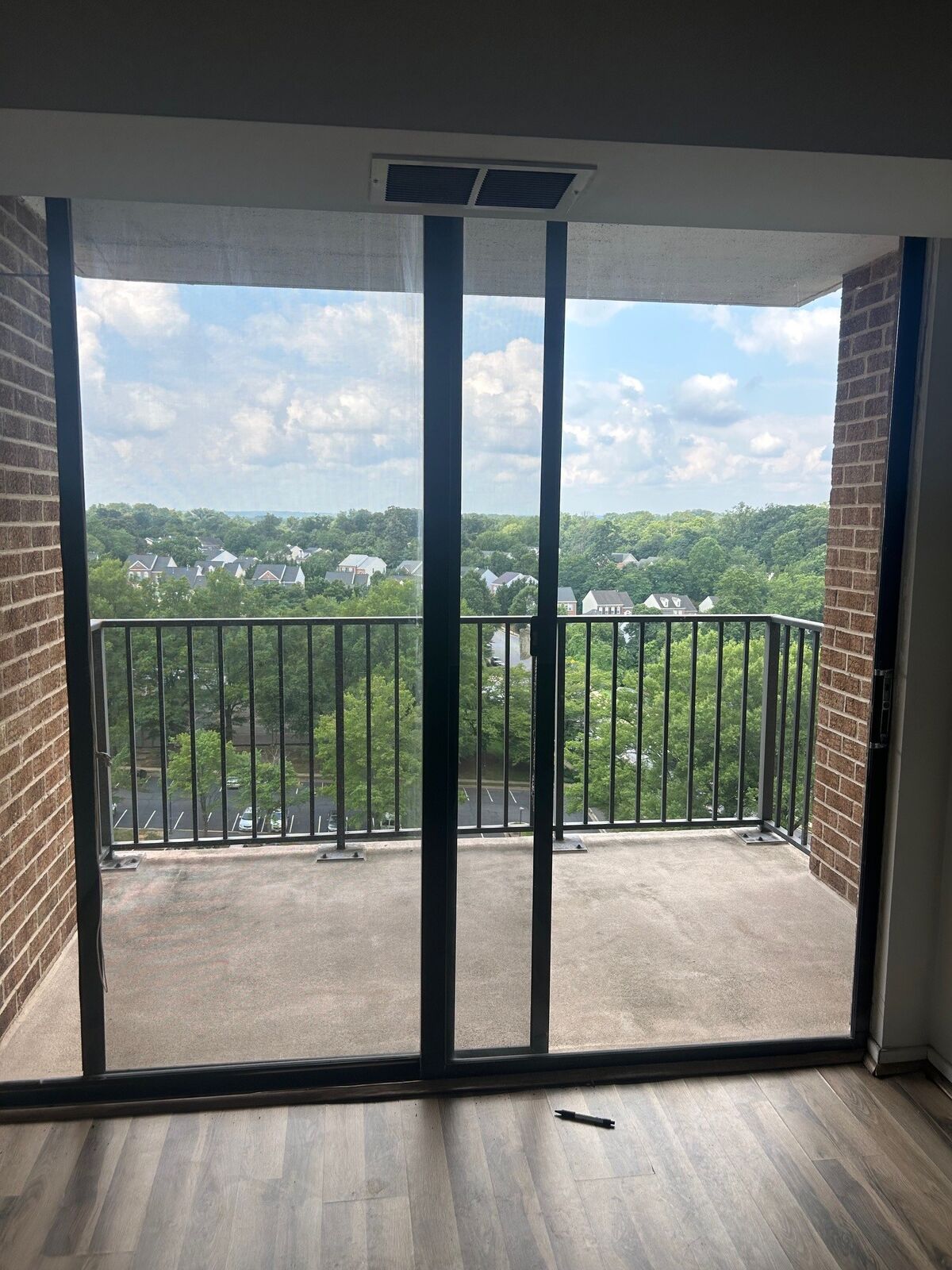 A dark-framed sliding patio door opening onto a balcony