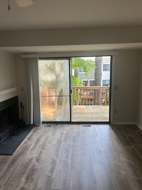 A sliding patio door in an empty living room with a fogged left panel and a clear right panel.