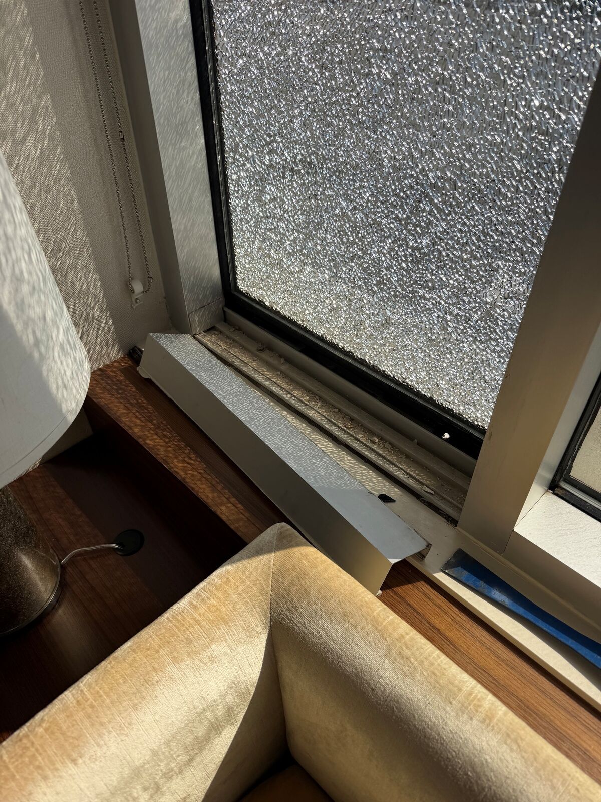 A window pane with an extensive shattered-glass pattern across it