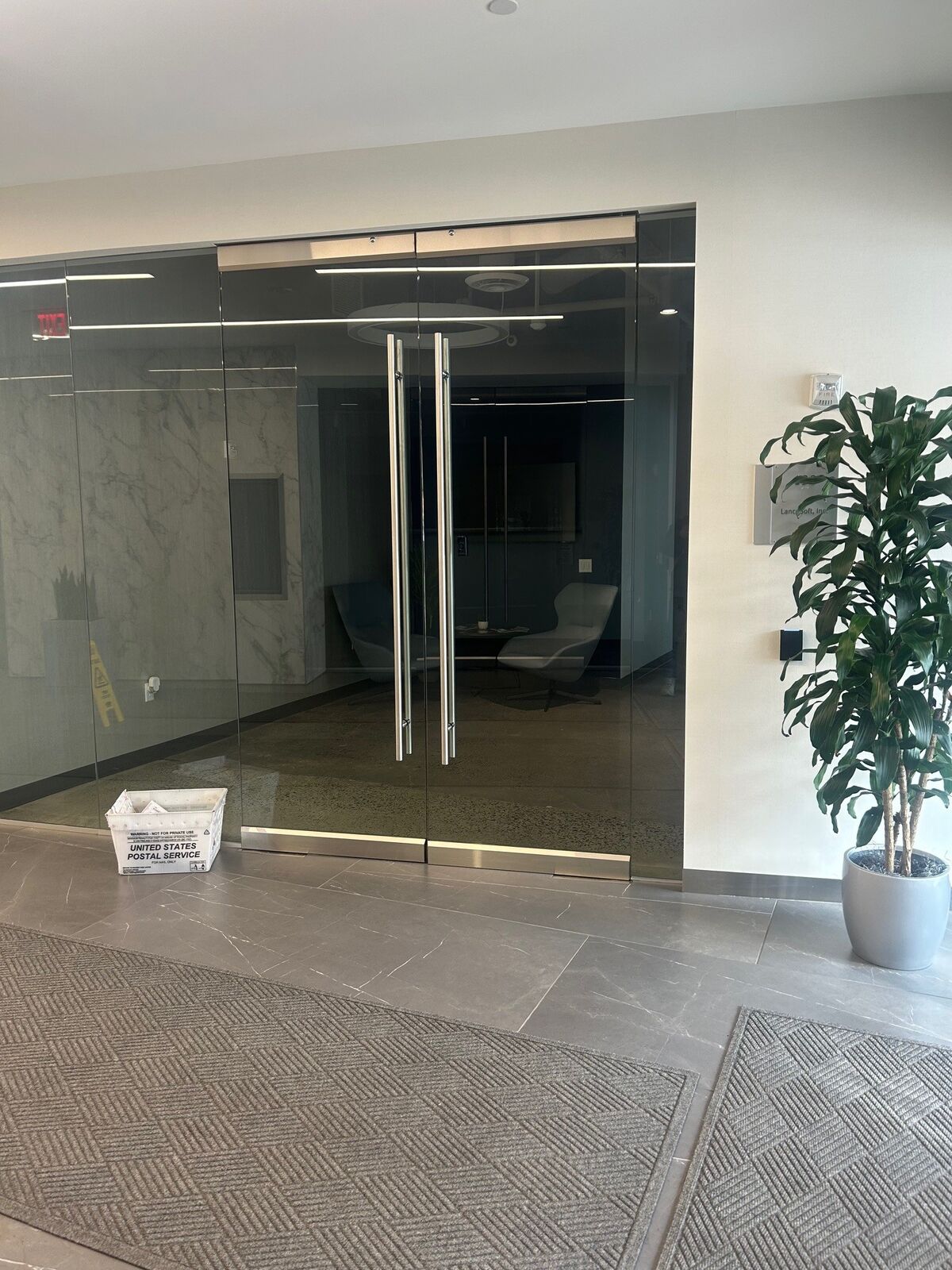 Clear frameless double glass doors with long vertical pull handles