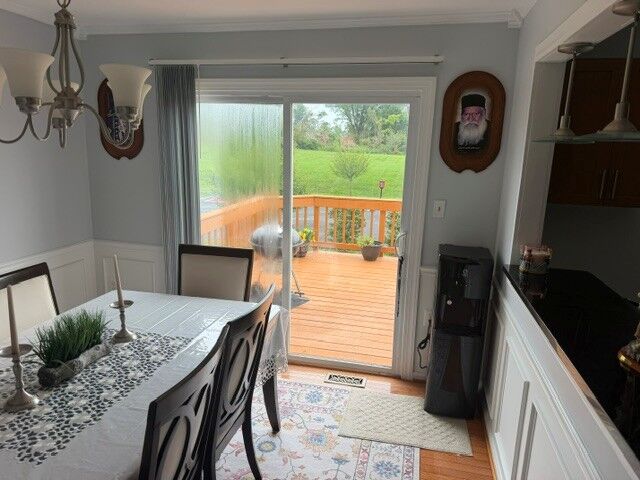 A sliding patio door beside a dining table, with condensation streaks in the left glass panel and a clear view through the right.