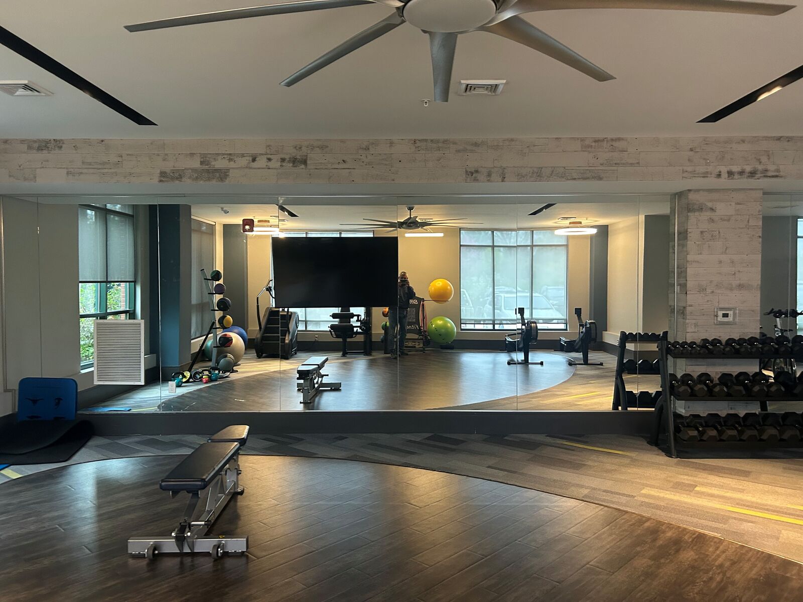 A large mirror wall reflecting the floor of a fitness center