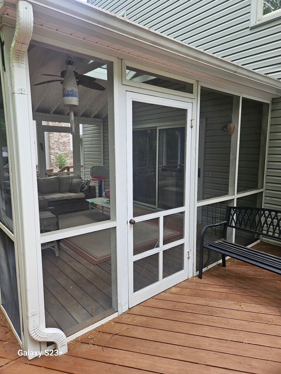 A screened porch entry door on a deck