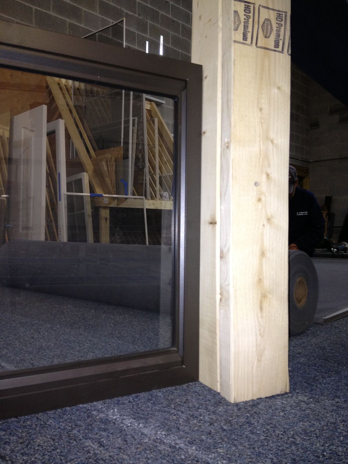 A dark-framed window unit displayed in a workshop