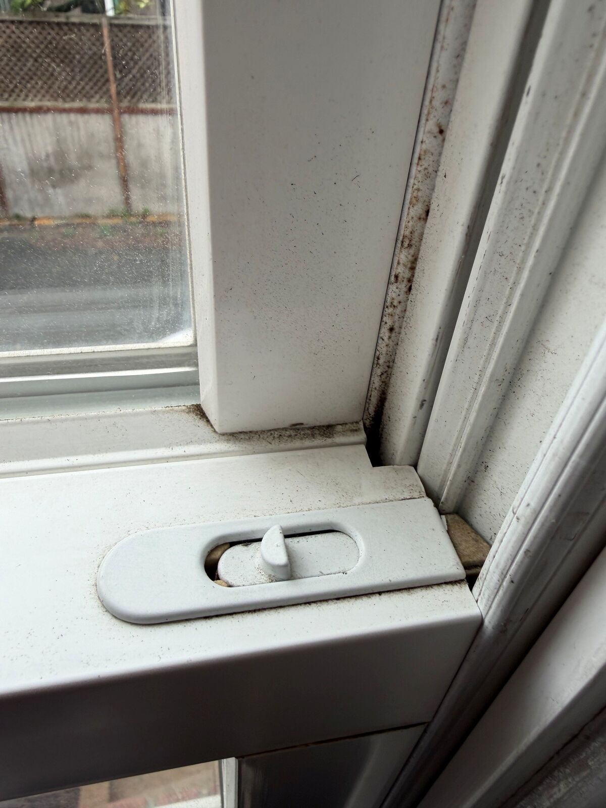 Close-up of a window tilt latch and the side track