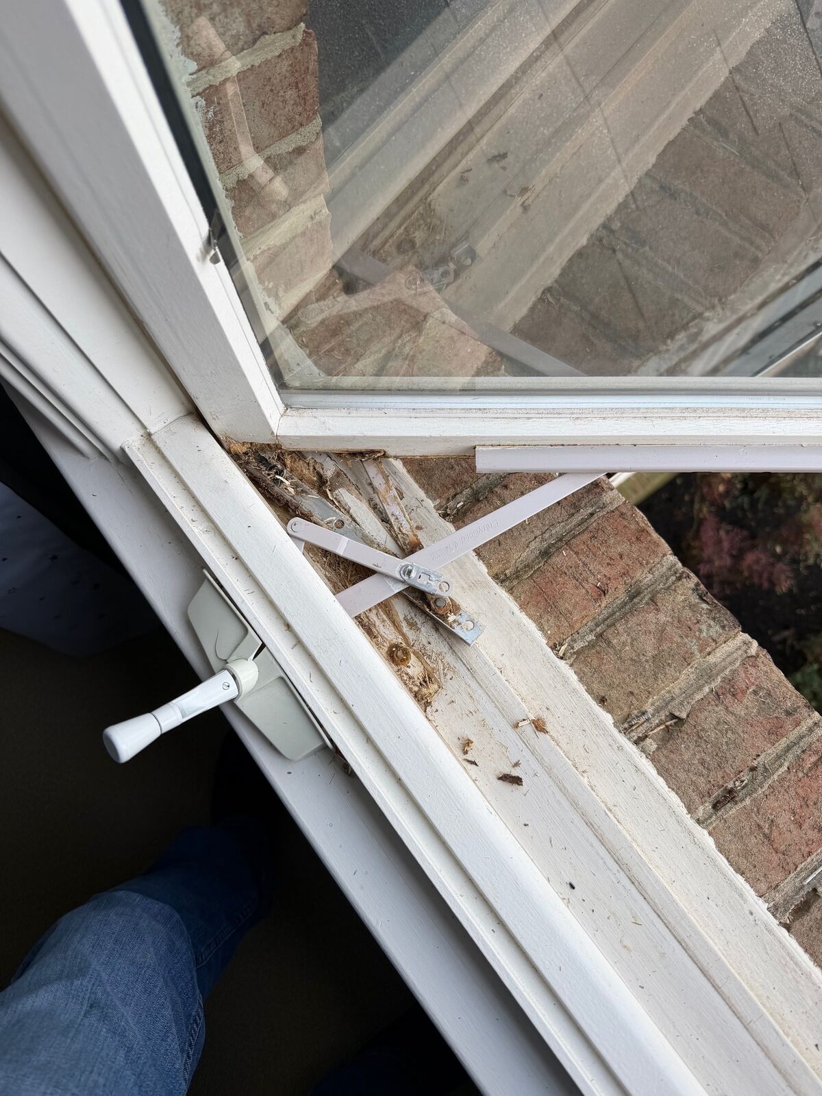 Close-up of a casement window sill with worn wood